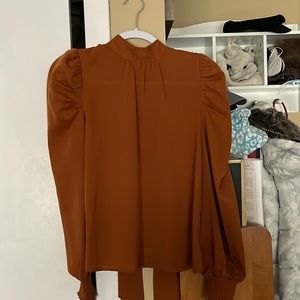 Rust orange blouse.